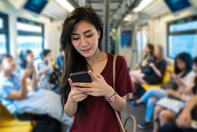 Female viewing phone on subway