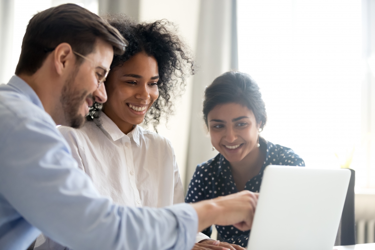 Three people looking at a computer screen